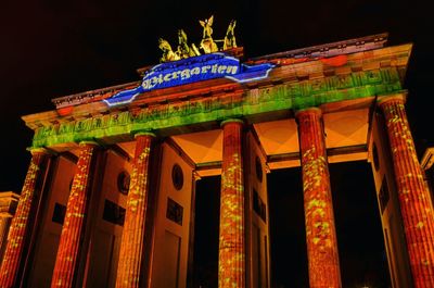 Low angle view of illuminated building at night