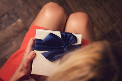 High angle view of woman holding christmas present