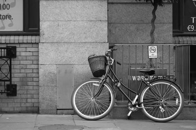 Bicycle against building in city