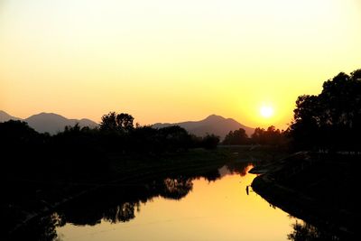 Scenic view of river at sunset