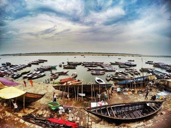 Boats moored on beach against sky