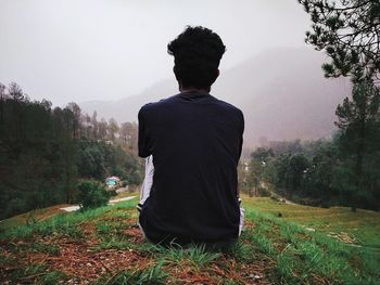 Rear view of man looking at mountains