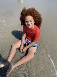 High angle view of boy playing at beach