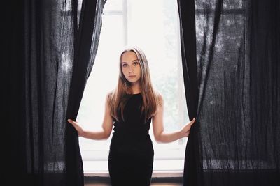 Woman standing by window