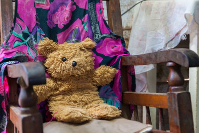 Close-up of toy placed on wooden chair