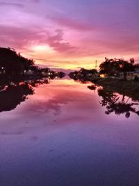 Scenic view of lake against romantic sky at sunset