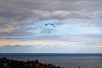 Scenic view of paragliding at sunset