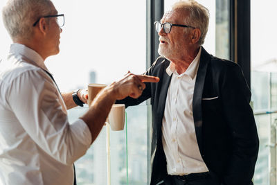 Side view of a man holding camera