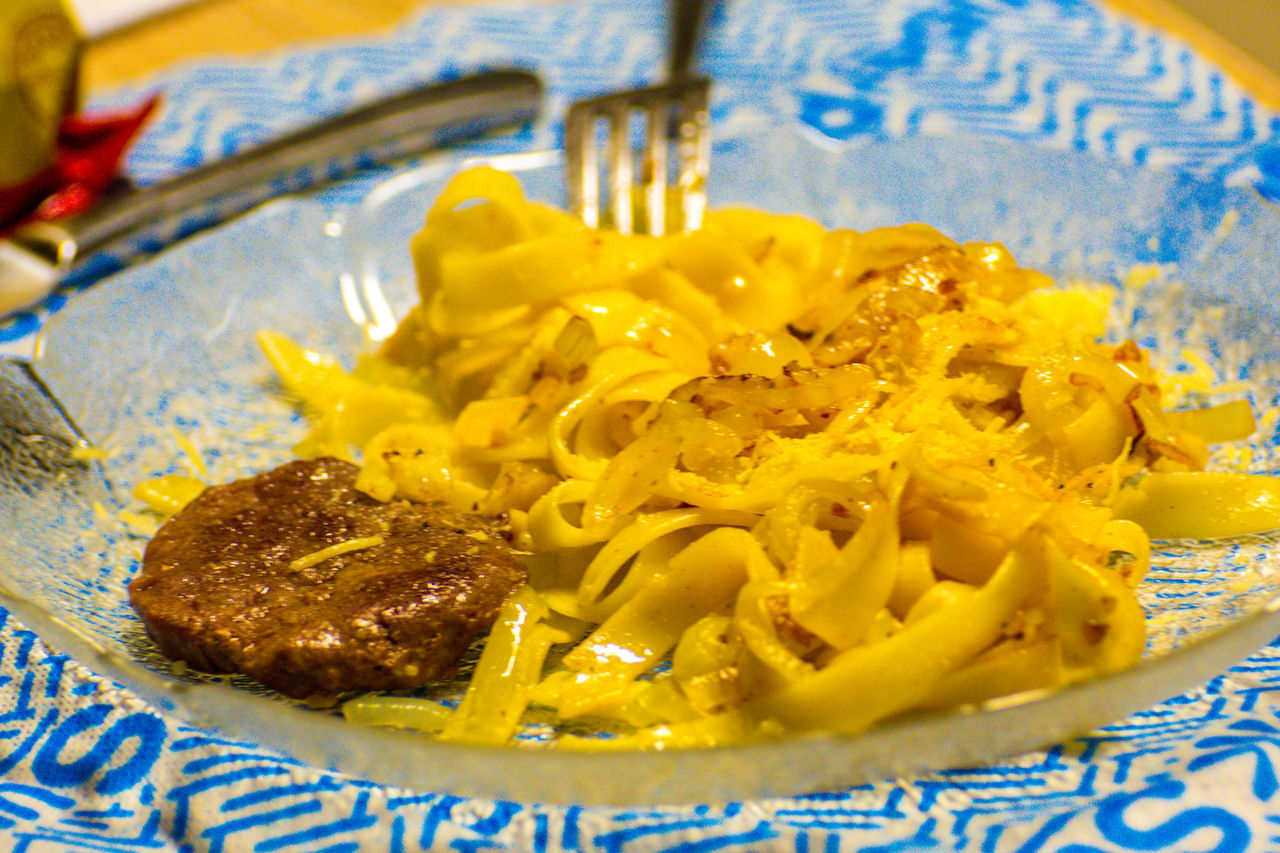 CLOSE-UP OF YELLOW FOOD SERVED ON TABLE