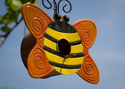 Low angle view of decoration hanging against sky