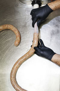 Overhead view of chef making sausage in commercial kitchen
