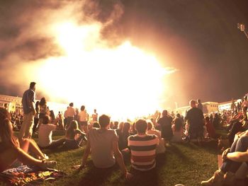 Panoramic view of crowd on field against sky at night