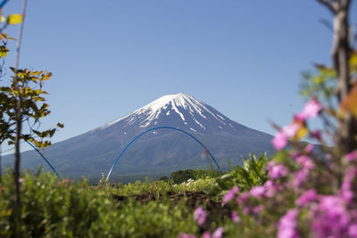 Scenic view of snowcapped mountains against clear blue sky