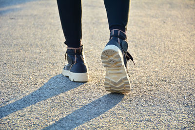 Low section of woman running on road