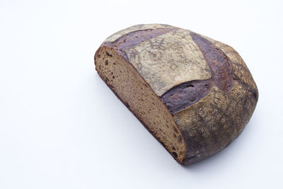 High angle view of bread on rock against white background