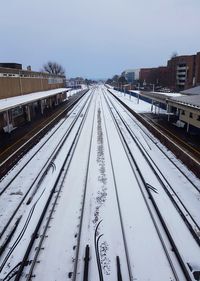 Railway tracks against clear sky during winter
