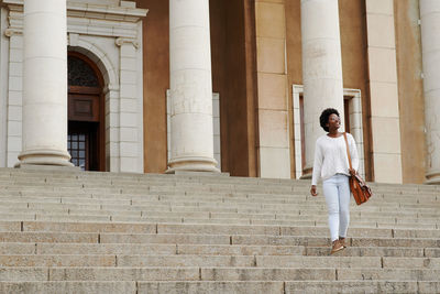 Low angle view of woman against building