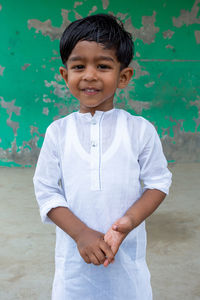 Portrait of smiling boy standing outdoors