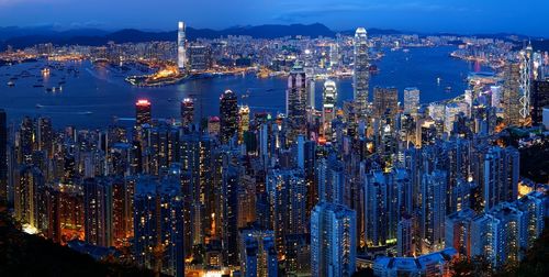 High angle view of city lit up at night