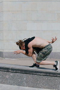 Full length of woman on retaining wall