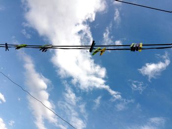 Low angle view of cables against blue sky