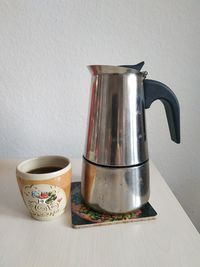 Close-up of coffee on table against wall at home