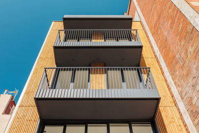 Low angle view of modern building against clear blue sky