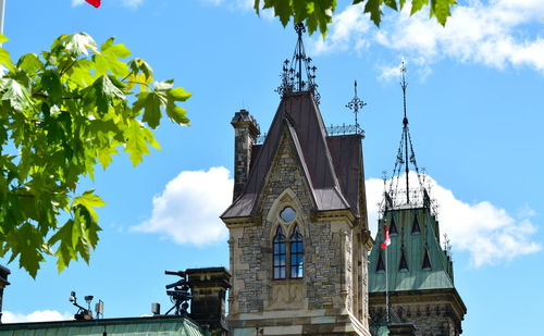 Low angle view of bell tower against blue sky