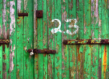Full frame shot of weathered green wooden door