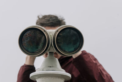 Man looking through binocular