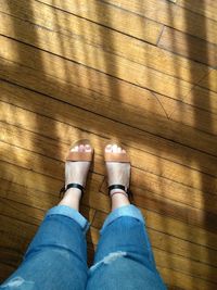 Low section of woman standing on tiled floor