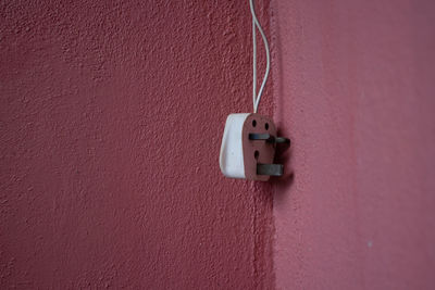 Close-up of electric lamp on wall