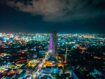 High angle view of illuminated city against sky at night