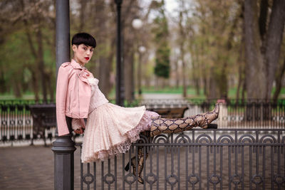 Portrait of young woman sitting outdoors