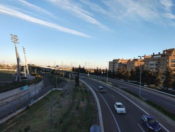 Road by city against sky