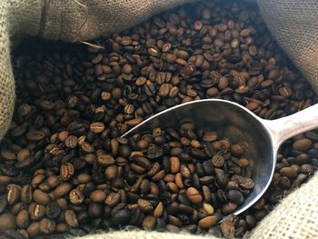 Close-up of roasted coffee beans in sack