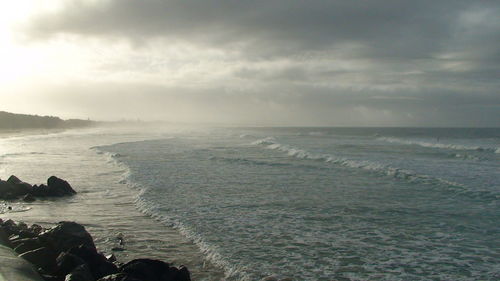 Scenic view of sea against cloudy sky