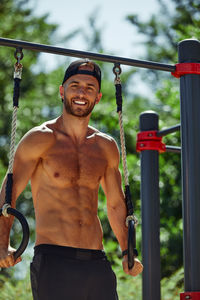 Portrait of young man exercising in playground