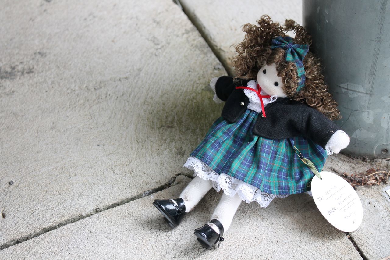 blue, childhood, child, full length, clothing, one person, toy, footwear, day, sitting, pattern, high angle view, cute, female, women, footpath, outdoors, white, spring, person, stuffed toy