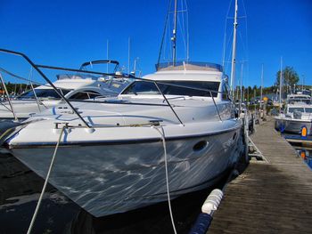 Sailboats moored in marina