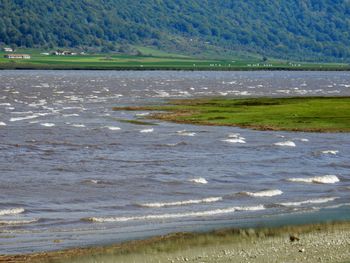 Scenic view of sea against mountains