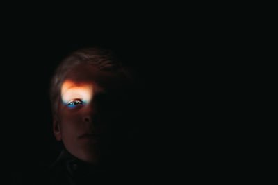 Young boy with rainbow flare on eye