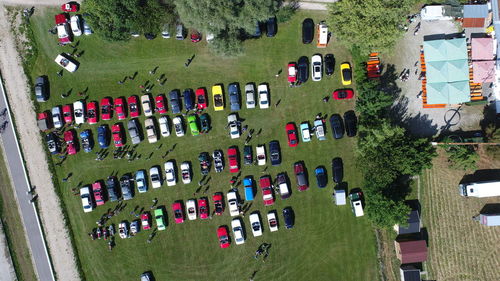 High angle view of cars on grass in city