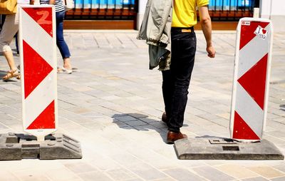 Low section of woman walking in city