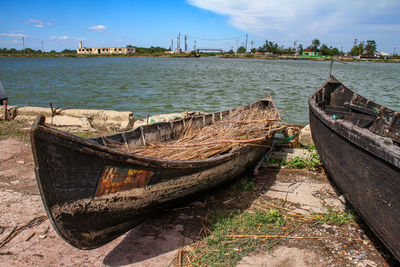 Boats moored in sea against sky