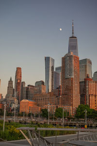 Buildings in city against clear sky