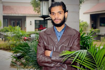 Portrait of young man standing in yard