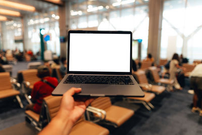 Midsection of woman using laptop on table