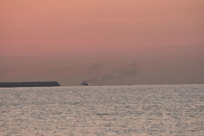 Scenic view of sea against sky at sunset