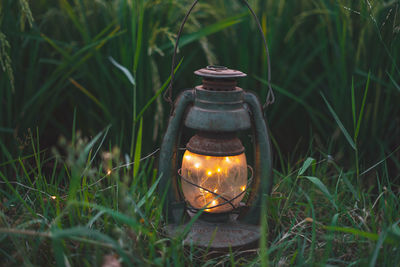 Close-up of illuminated lantern on field